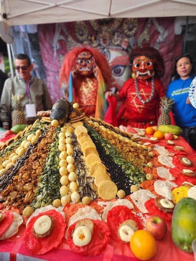 Traditional Samay Baji feast spread with Bhairav performers in the background